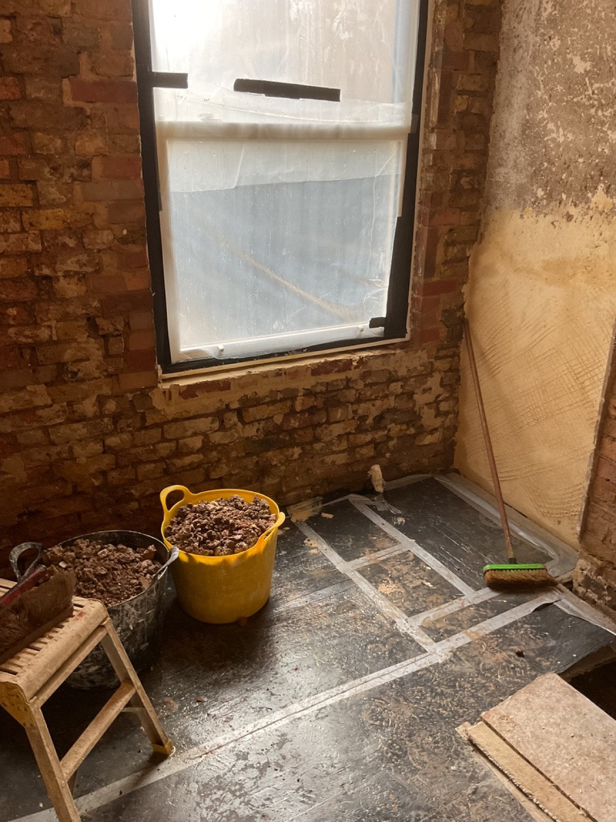 Stripped solid masonry wall before lime plaster repair